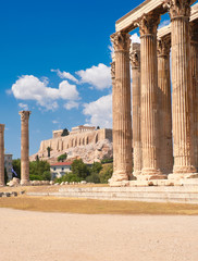 Temple of Zeus with Acropolis on the background in Athens, Greece on a bright day, ruins of...