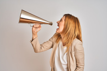 Young beautiful readhead businesswoman screaming using vintage megaphone