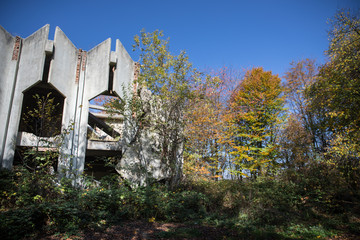 Autumn forest and old soviet building. Azerbaijan Ganja