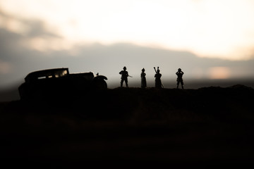 Fototapeta premium War concept. Creative composition. Silhouette of German general at the desert. Army commanders watching to the battle.