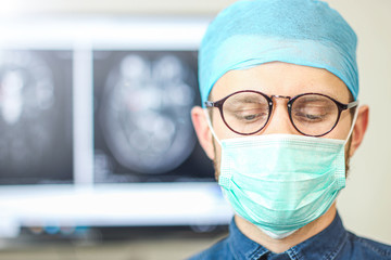 Male surgeon in glasses and uniform in a hospital in the operating room. Portrait of a specialist.