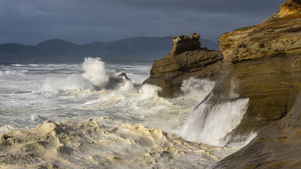 Waves crashing against rocks at Cape Kiwanda State Natural Area near Pacific City, Oregon.
