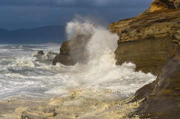 Waves crashing against rocks at Cape Kiwanda State Natural Area near Pacific City, Oregon.