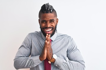 African american businessman with braids wearing tie standing over isolated white background...