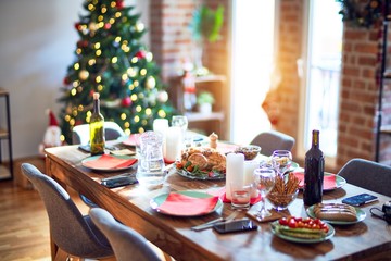 Nice home with tree, decorations and table with food prepared to celebrate Christmas