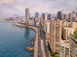 Obraz premium Beirut's corniche sea front with high rise residential buildings and pedestrian walkway along the Mediterranean sea, Lebanon