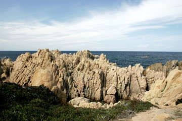 Fototapeta na wymiar rocks and blue sea, bay in Costa Paradiso, Sardinia Italy