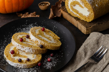 Pumpkin Roll with powdered sugar with walnuts pumpkin seeds and lingonberry