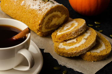 Pumpkin Roll with powdered sugar with walnuts and pumpkin seeds and cup of coffee