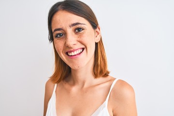 Beautiful redhead woman wearing casual white t-shirt over isolated background with a happy face standing and smiling with a confident smile showing teeth