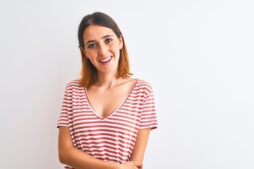 Obraz premium Beautiful redhead woman wearing casual striped red t-shirt over isolated background happy face smiling with crossed arms looking at the camera. Positive person.