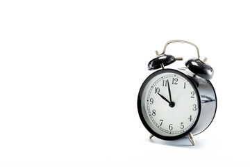 black vintage alarm clock on white background