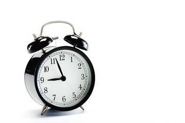 black vintage alarm clock on white background