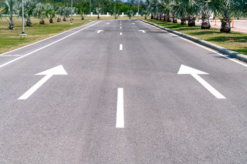 asphalt road with white arrow