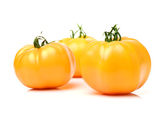 fresh yellow tomatoes on white background