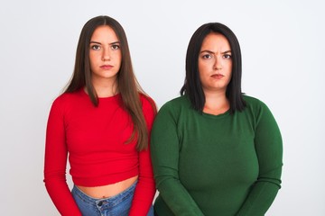 Young beautiful women wearing casual clothes standing over isolated white background skeptic and...