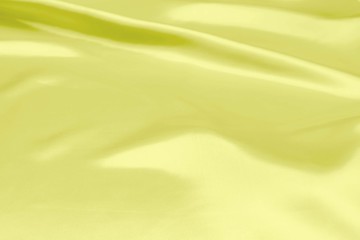 Fototapeta na wymiar Yellow satin fabric texture soft blur background