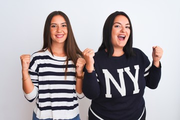 Young beautiful women wearing casual clothes standing over isolated white background celebrating surprised and amazed for success with arms raised and open eyes. Winner concept.