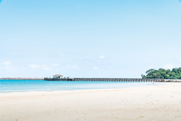 Jetty with sea view and blue sky in summer at coast of Thailand