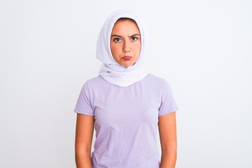 Young beautiful arabian girl wearing hijab standing over isolated white background depressed and worry for distress, crying angry and afraid. Sad expression.