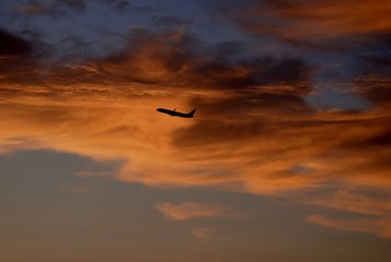 Plane taking off at sunset