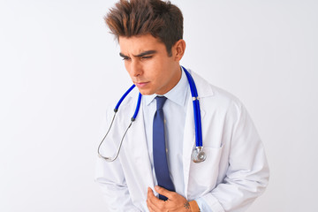Young handsome doctor man wearing stethoscope over isolated white background with hand on stomach because indigestion, painful illness feeling unwell. Ache concept.