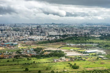 Obraz premium Bangalore to Pune, , a large green field with a mountain in the background