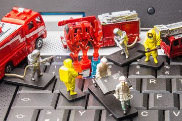 Firefighters and rescue teams on keyboard computer laptop.Computer equipment.Computer repair concept.