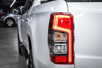  Close up detail on one of the LED  red taillight modern white crossover car. Exterior detail automobile..