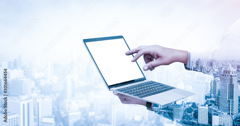 Poster double exposure image of businessman using computer on abstract modern city background. future busin