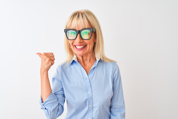 Middle age businesswoman wearing sunglasses and shirt over isolated white background pointing and showing with thumb up to the side with happy face smiling