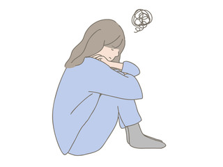 寝巻姿で落ち込む女性