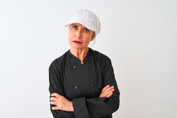 Middle age chef woman wearing uniform and cap standing over isolated white background skeptic and nervous, disapproving expression on face with crossed arms. Negative person.