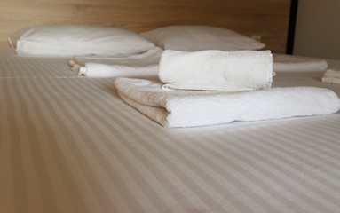 Service in the hotel room. New and clean bed linen and towels on the beds