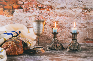 Sabbath Jewish Holiday challah bread and candelas on wooden table
