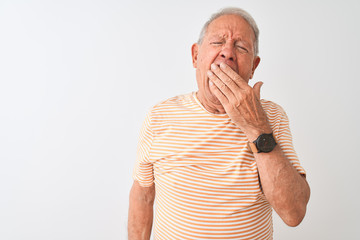 Senior grey-haired man wearing striped t-shirt standing over isolated white background bored...