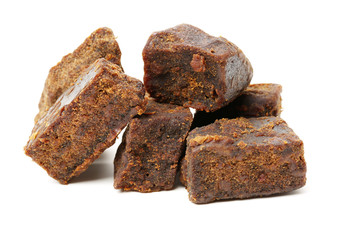 brown cubes of sugar on white background