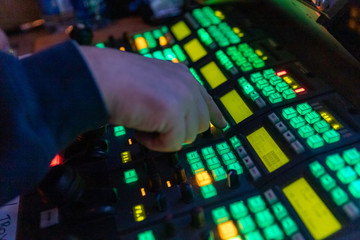 Video Operator makes adjustments on a professional broadcast television camera, shallow depth of...