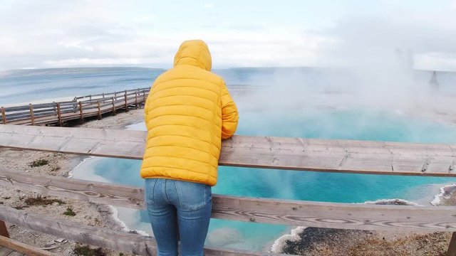 Traveler walks around Norris geyser basin in Yellowstone National Park, travel around the United States, unique place, geothermal areas, feeling exited
