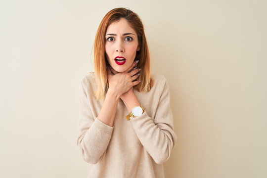 Redhead woman wearing elegant turtleneck sweater standing over isolated white background shouting and suffocate because painful strangle. Health problem. Asphyxiate and suicide concept.
