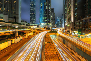 Fototapeta na wymiar Long exposure of Hong Kong Cityscape skyscaper which have light traffic transportation from car or bus on Central Business District around IFC building, Hong Kong