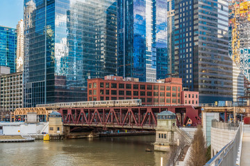 Chicago River walk with Yacht running and traing running over the rail track, illinois, USA....