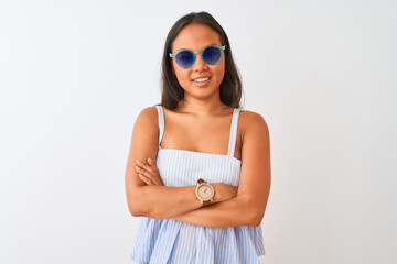 Young chinese woman wearing striped dress and sunglasses over isolated white background happy face smiling with crossed arms looking at the camera. Positive person.