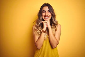 Young beautiful woman wearing t-shirt over yellow isolated background laughing nervous and excited...