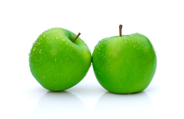 Closeup fresh two green granny smith apples with water drops isolated on white background with clipping path. Full depth of field.