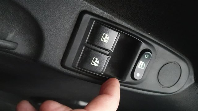 turning on the electric window in the car . vertical video