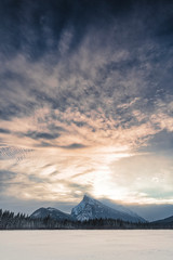 Sunset landscapes of Vermillion Lake in Banff Alberta Canada with large mountains, frozen lakes and snow covered hills.