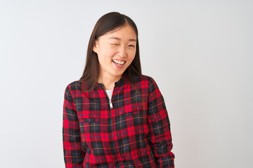 Young chinese woman wearing casual jacket standing over isolated white background winking looking at the camera with sexy expression, cheerful and happy face.