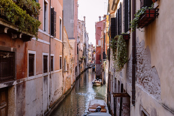 Panoramic view of Venice narrow canal with historical buildings and boat