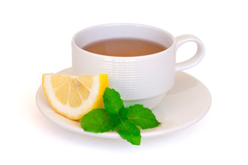 White cup of green tea with fresh mint leaf and yellow lemon sliced isolated on white background with clipping path. Healthy drinks concept.